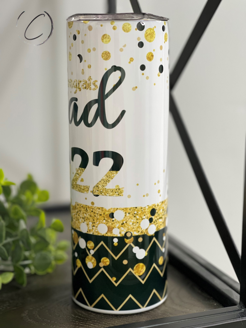 A stylish 20oz Skinny Tumbler celebrating graduation 2022 with a full wrap design and reusable straw.