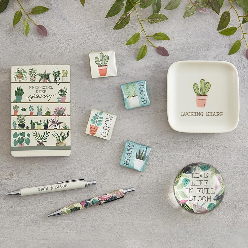 Grow & Bloom Pen Set of 2 featuring a white pen with 'Grow and Bloom' text and a colorful foliage print pen in teal, pink, and green, elegantly boxed.