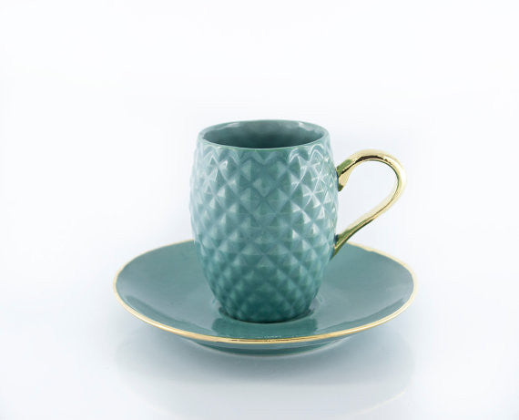 Handmade blue ceramic espresso cup with pineapple pattern and real gold accented handle, elegantly designed for coffee lovers.