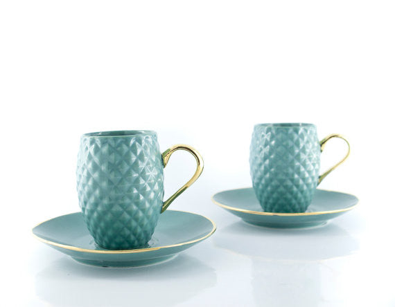 Handmade blue ceramic espresso cup with pineapple pattern and real gold accented handle, elegantly designed for coffee lovers.