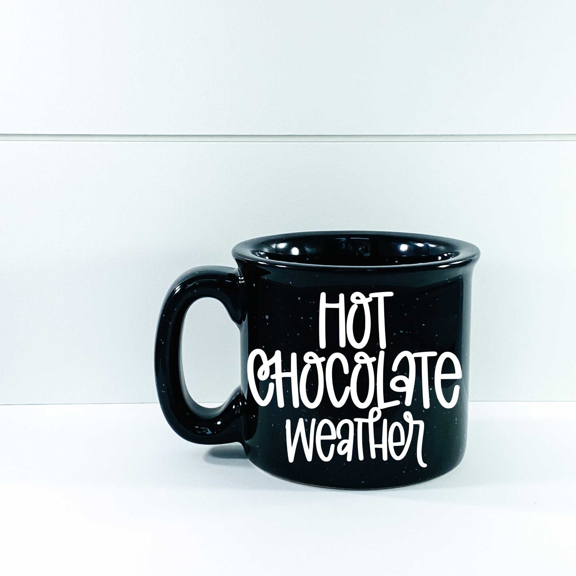 A cozy ceramic campfire mug designed for hot chocolate, featuring a vibrant vinyl design, perfect for chilly weather.