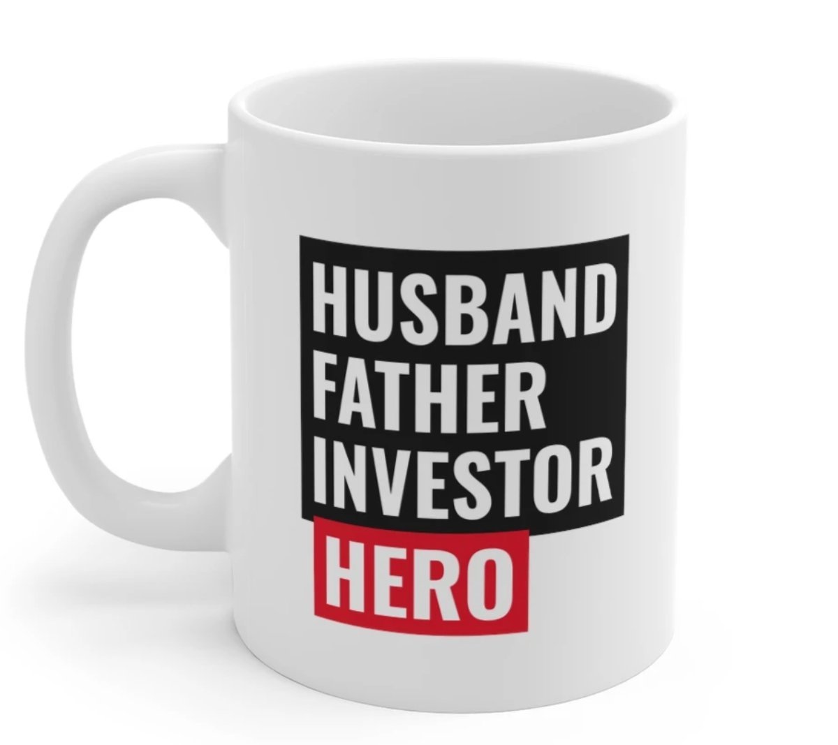 A white ceramic mug featuring the text 'Husband, Father, Investor, Hero' with a classic rounded design and C-handle.