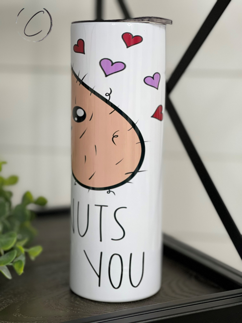 I'm Nuts About You 20oz Skinny Tumbler with a vibrant design, featuring a reusable straw and a sleek, insulated body.