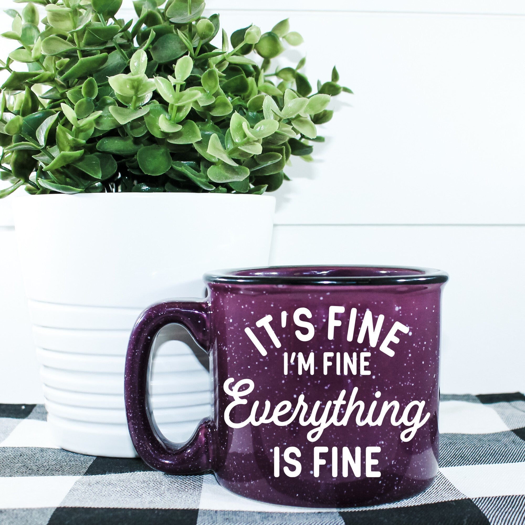 Ceramic campfire mug with 'It's Fine I'm Fine Everything's Fine' design, perfect for cozy drinks.