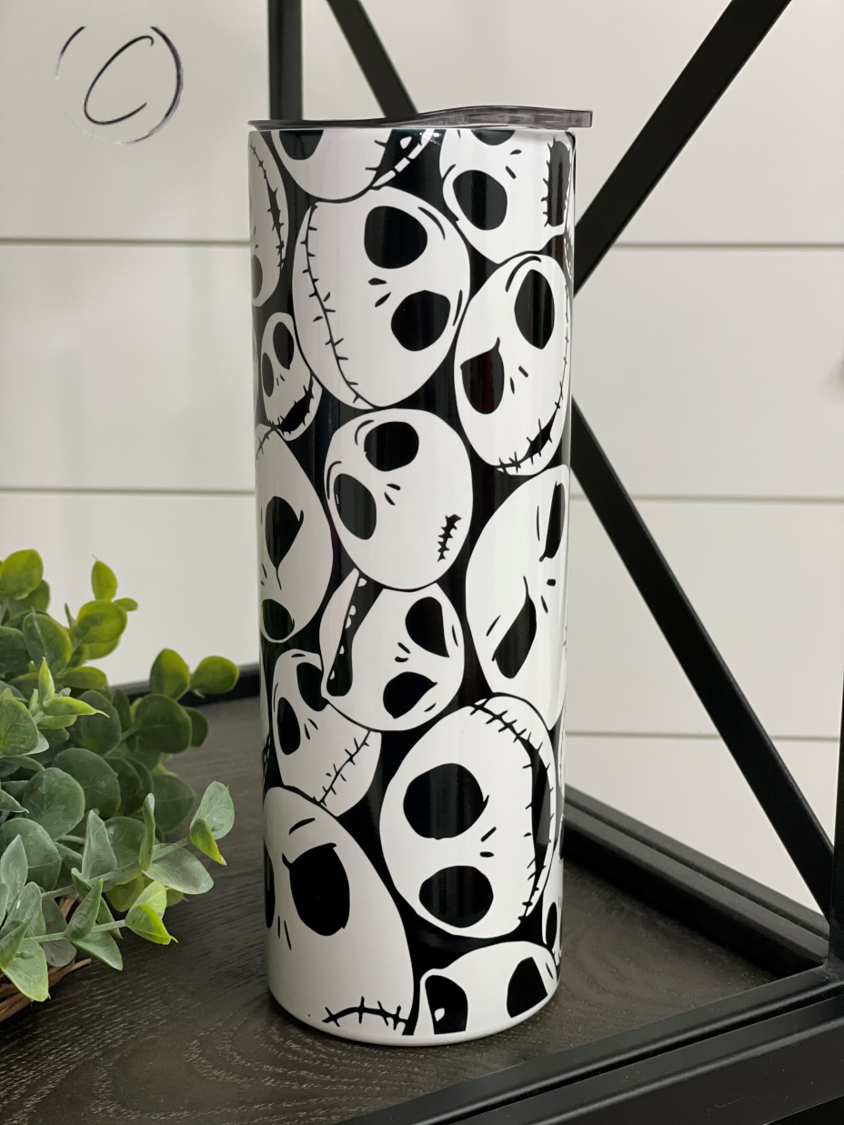 Jack Skellington 20oz UV Orange Skinny Tumbler with color-changing effect in sunlight, featuring a full wrap design and reusable straw.