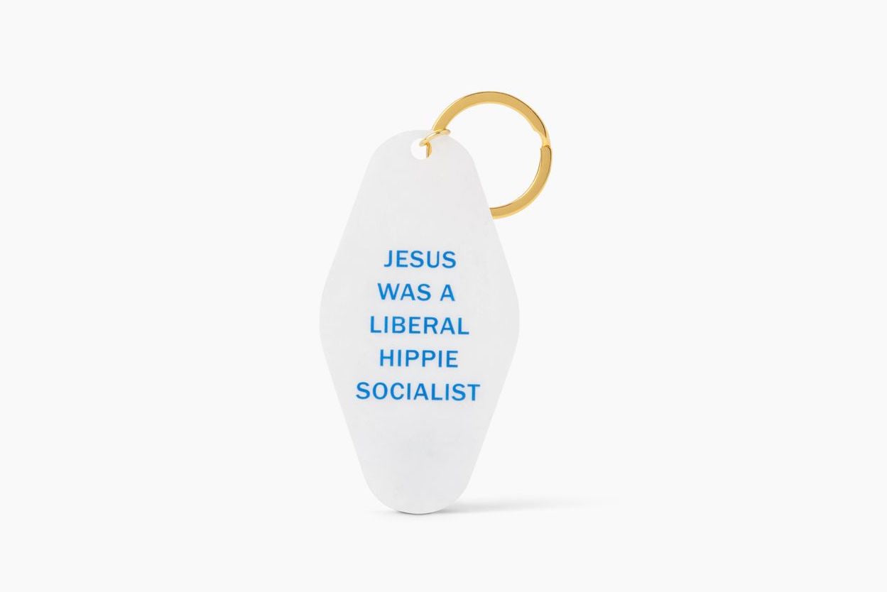 White shimmer keychain with text 'JESUS WAS A LIBERAL HIPPIE SOCIALIST' and a split ring attachment.