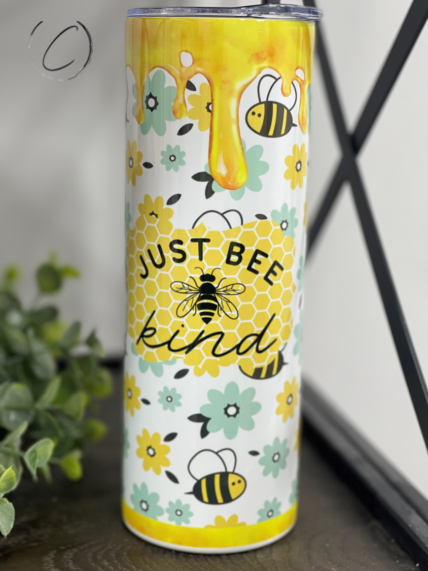 Just Bee Kind 20oz Skinny Tumbler with a vibrant full wrap design, featuring a reusable straw, perfect for hydration on the go.