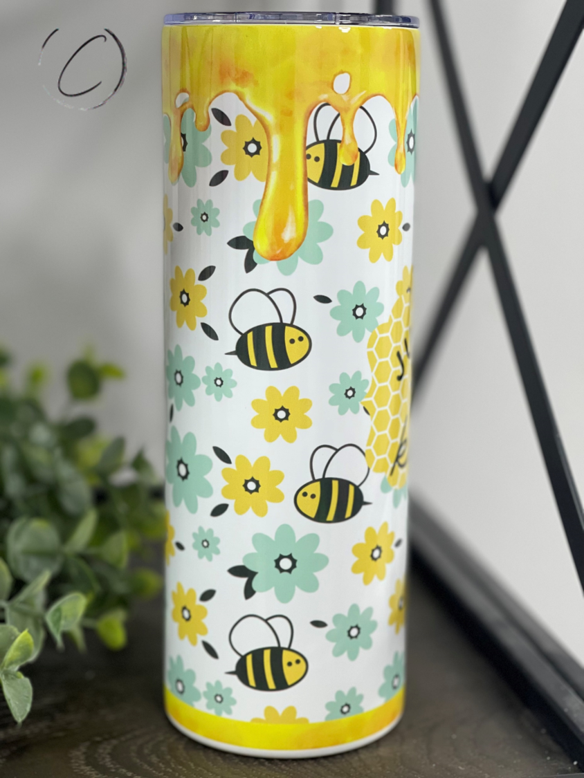 Just Bee Kind 20oz Skinny Tumbler with a vibrant full wrap design, featuring a reusable straw, perfect for hydration on the go.