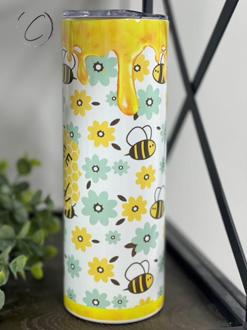 Just Bee Kind 20oz Skinny Tumbler with a vibrant full wrap design, featuring a reusable straw, perfect for hydration on the go.