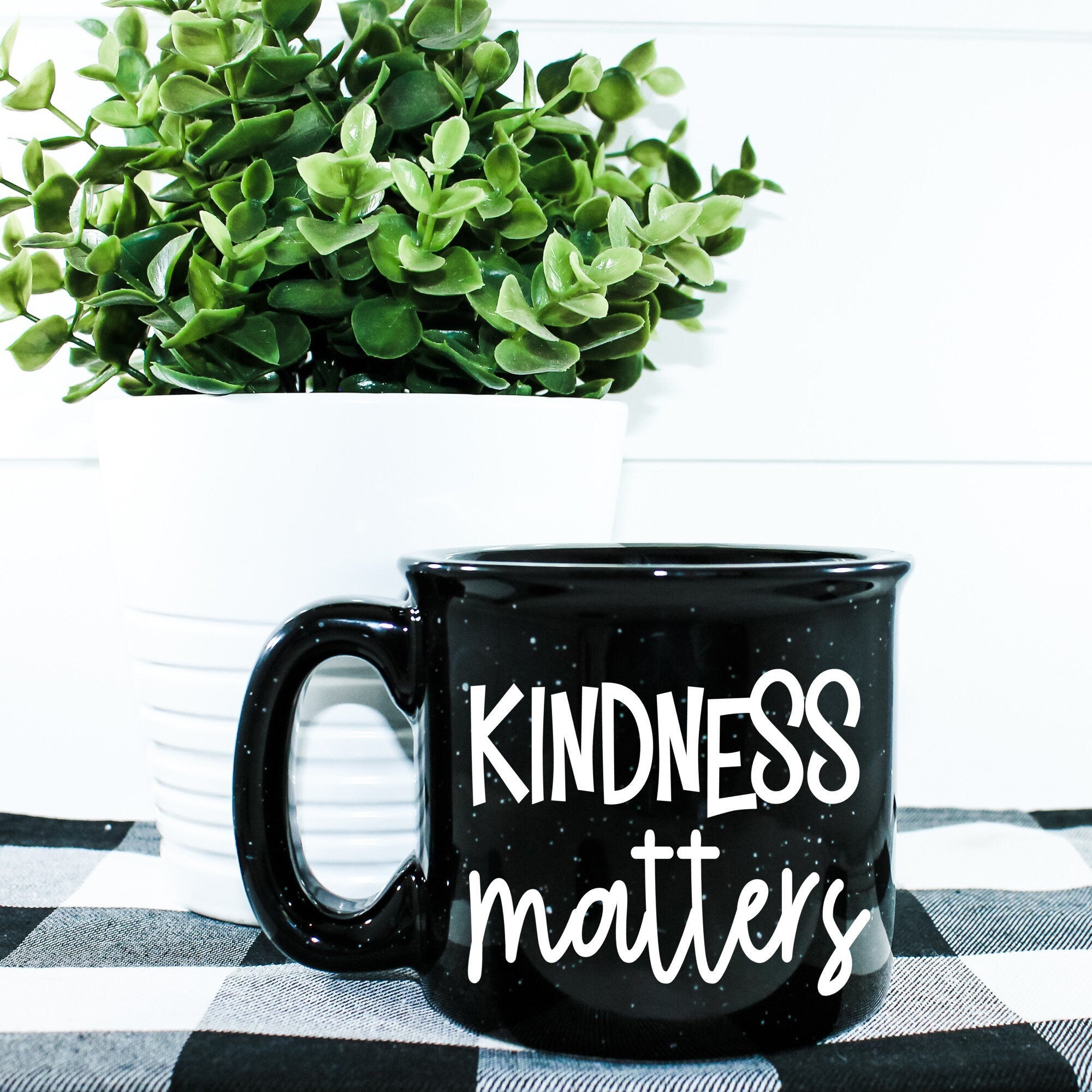 A stylish Kindness Matters Campfire Mug with a unique vinyl design, perfect for enjoying hot beverages.