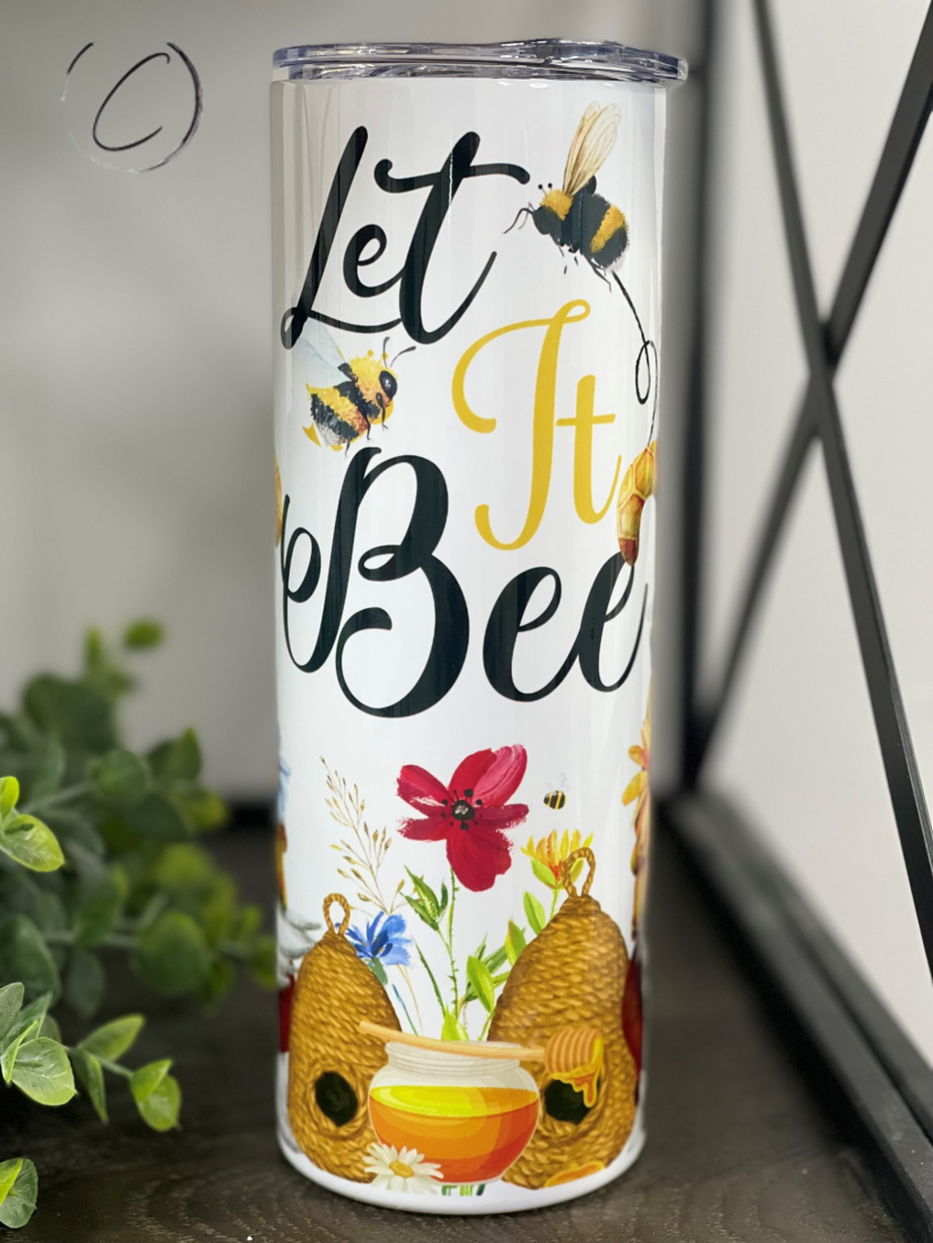 Let It Bee Gnomes 20oz Skinny Tumbler featuring a whimsical gnome design, perfect for hot and cold beverages.