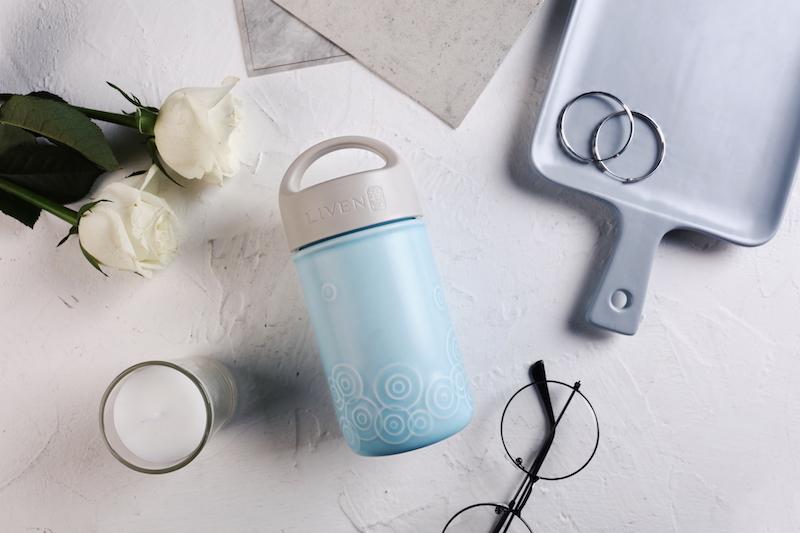 Liven Destiny Travel Mug featuring a tourmaline ceramic body, silicone cover, and convenient carrying handle, perfect for on-the-go hydration.