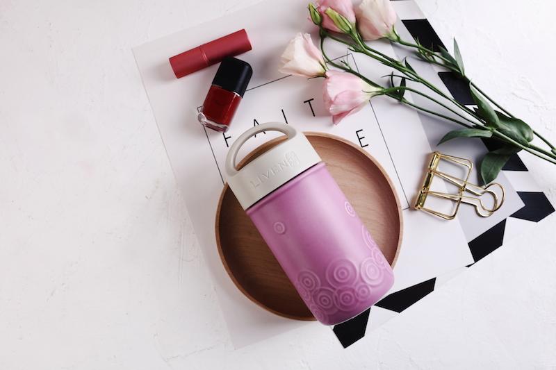 Liven Destiny Travel Mug featuring a tourmaline ceramic body, silicone cover, and convenient carrying handle, perfect for on-the-go hydration.