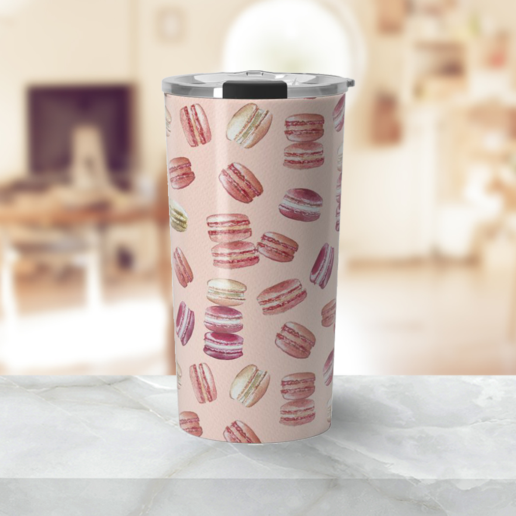 A stylish Macaron Travel Coffee Mug made of lightweight stainless steel, featuring vibrant wraparound artwork and a vacuum-sealed lid.