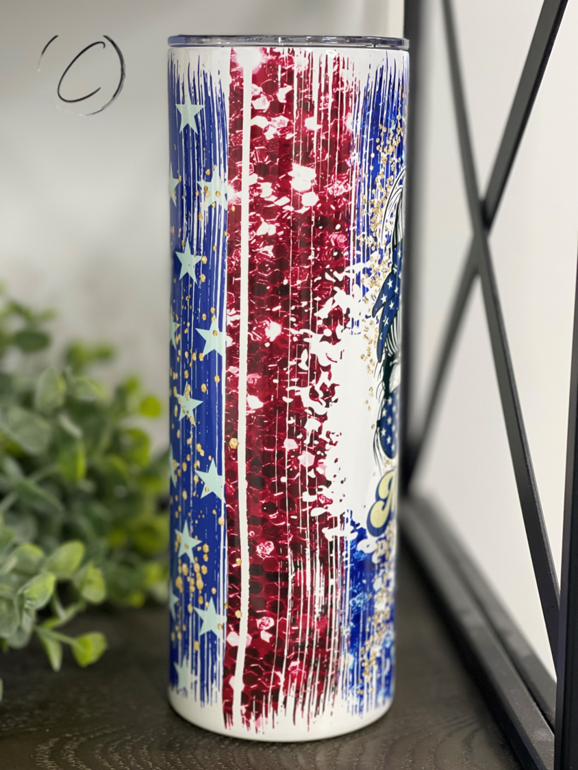 Merica 20oz Skinny Tumbler with full wrap design and reusable straw, showcasing vibrant colors and high-quality material.