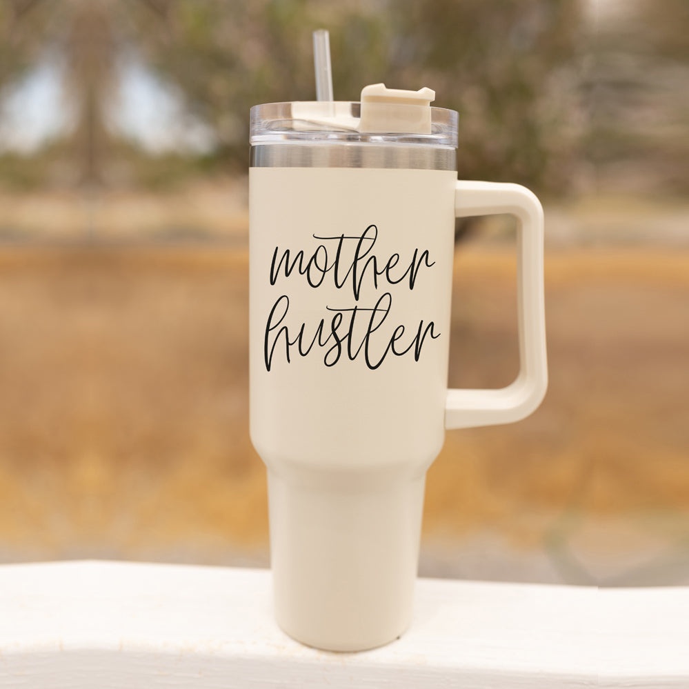 Mother Hustler 40oz tumbler with matte finish, featuring a bold black graphic on a cream exterior, designed for busy moms.