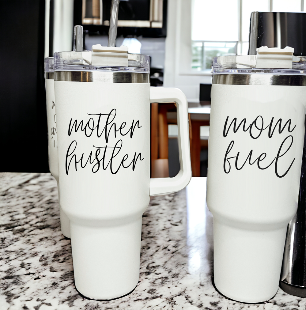 Mother Hustler 40oz tumbler with matte finish, featuring a bold black graphic on a cream exterior, designed for busy moms.