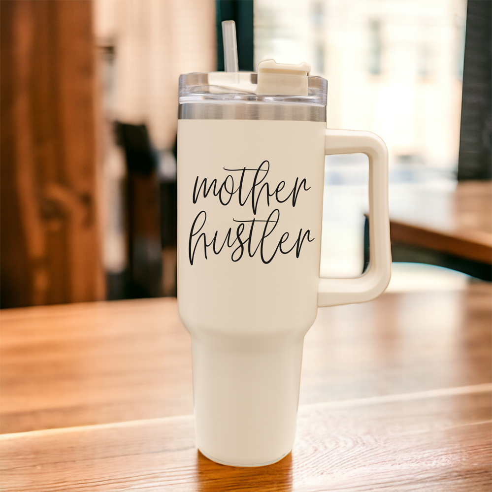 Mother Hustler 40oz tumbler with matte finish, featuring a bold black graphic on a cream exterior, designed for busy moms.