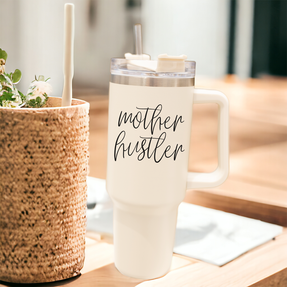 Mother Hustler 40oz tumbler with matte finish, featuring a bold black graphic on a cream exterior, designed for busy moms.