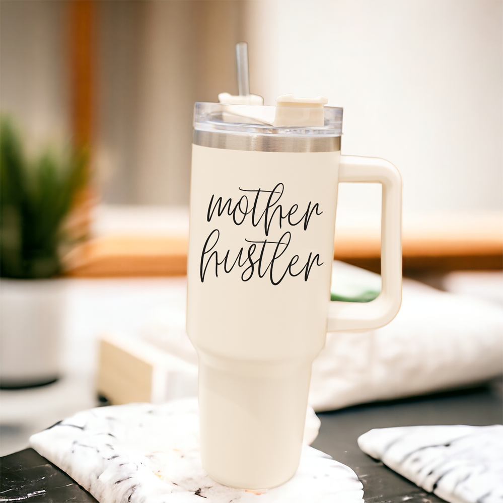 Mother Hustler 40oz tumbler with matte finish, featuring a bold black graphic on a cream exterior, designed for busy moms.