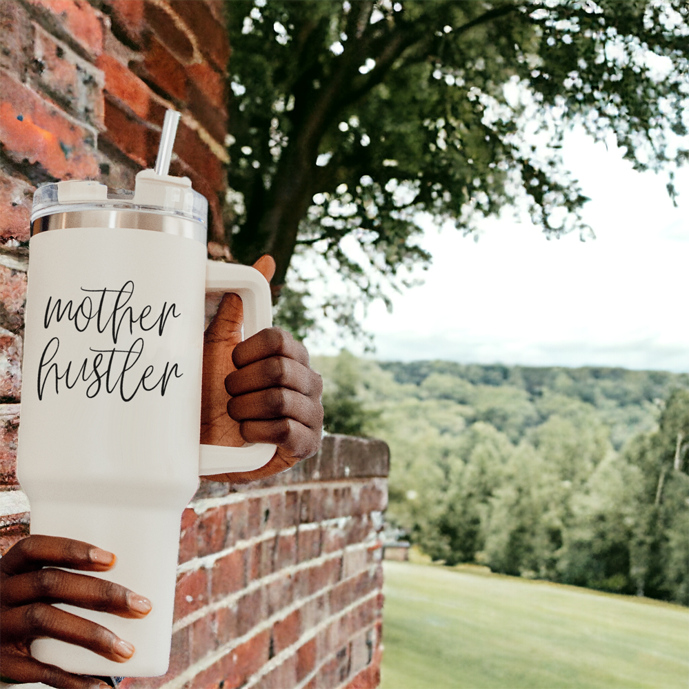 Mother Hustler 40oz tumbler with matte finish, featuring a bold black graphic on a cream exterior, designed for busy moms.