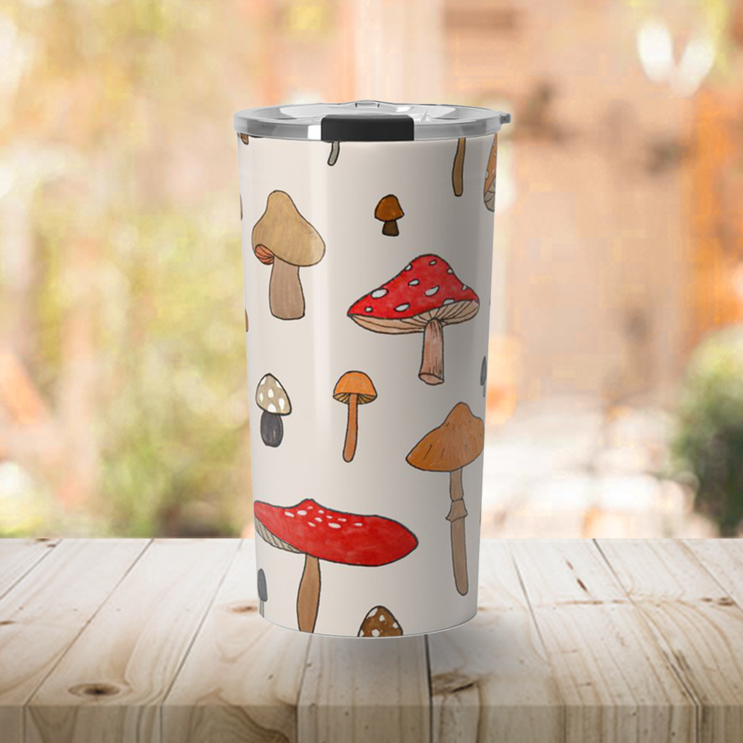 A stylish Mushroom Travel Mug made of stainless steel with a vibrant wraparound design, perfect for hot and cold beverages.