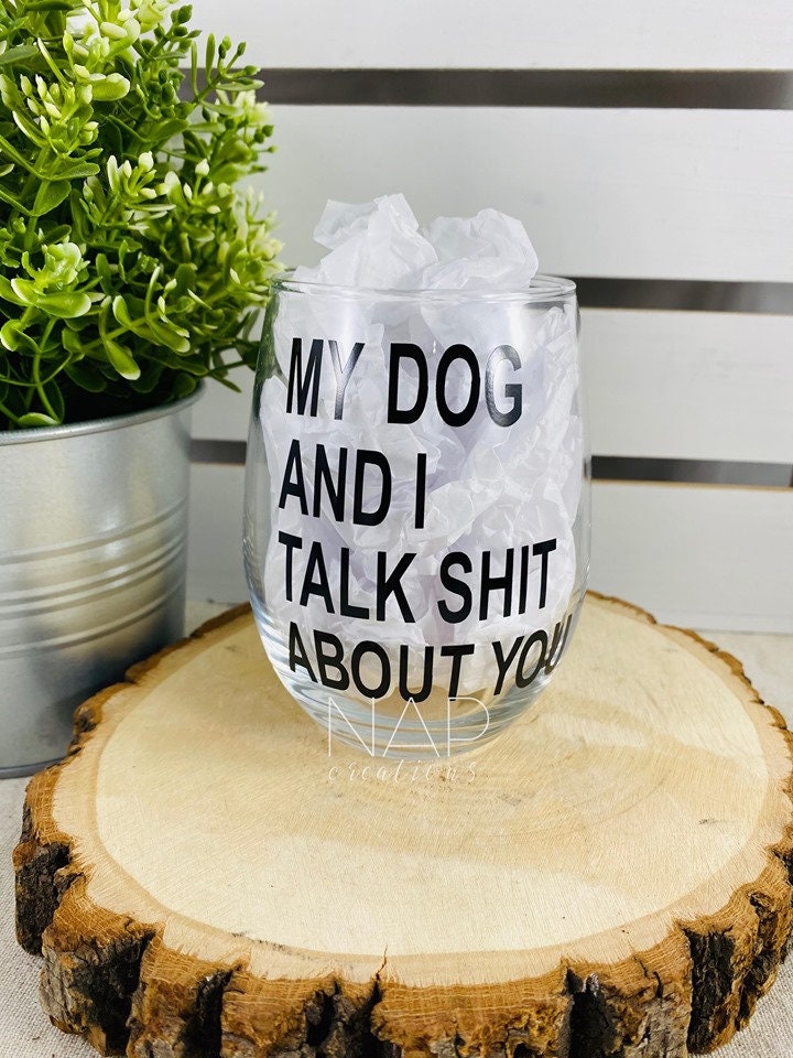 A humorous stemless wine glass featuring the phrase 'My Dog and I Talk Shit About You', perfect for dog lovers.