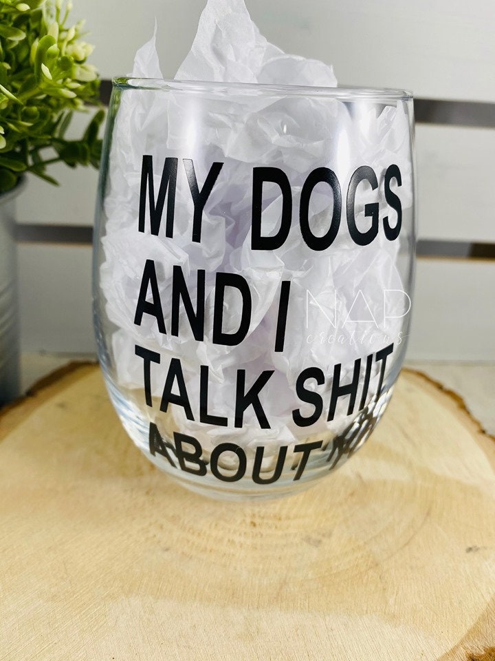 A humorous stemless wine glass featuring the phrase 'My Dog and I Talk Shit About You', perfect for dog lovers.