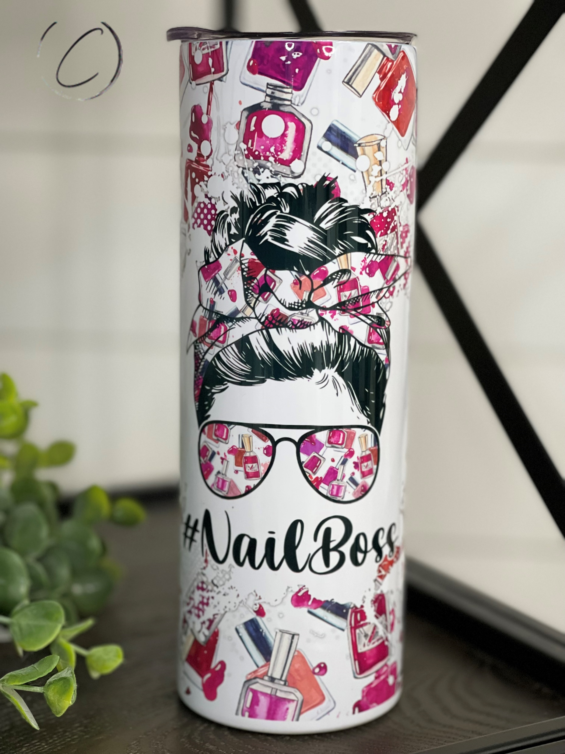 A stylish #NailBoss 20oz Skinny Tumbler featuring a vibrant full wrap design, perfect for hot and cold beverages.