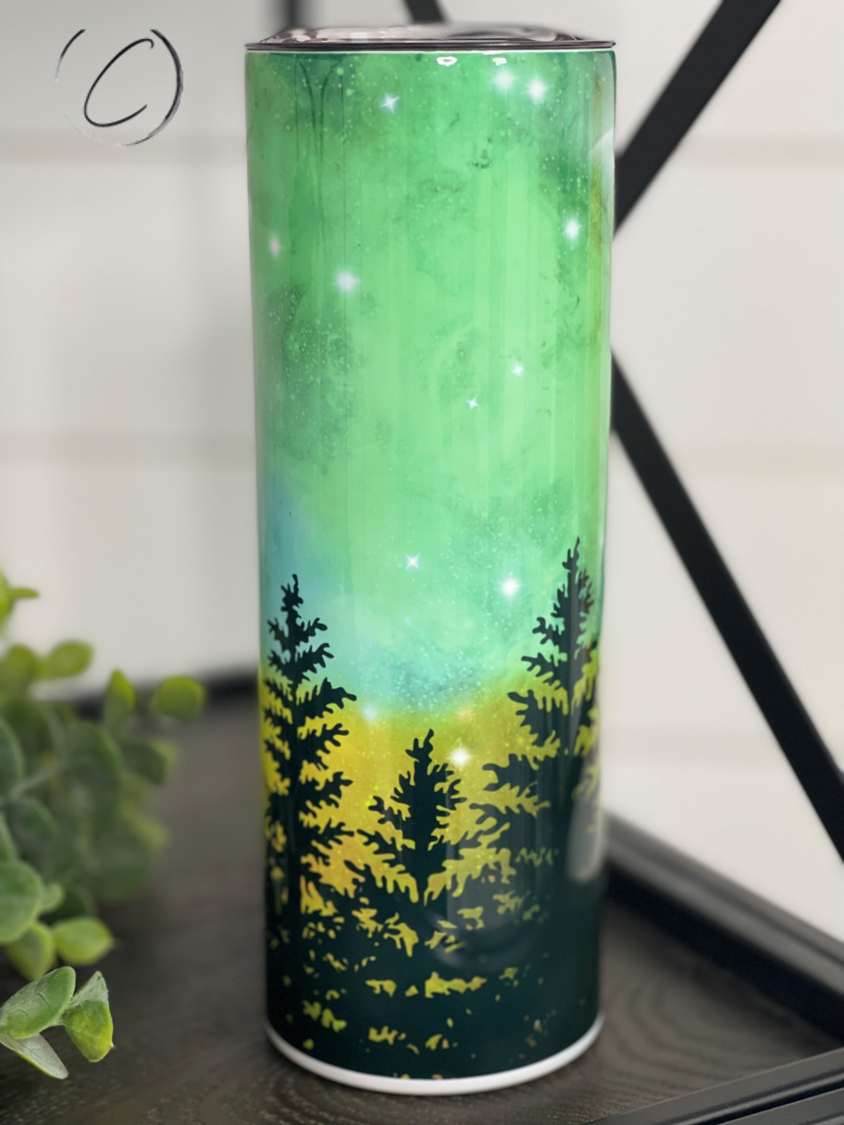 A 20oz skinny tumbler featuring a vibrant Northern Lights design, showcasing beautiful colors and a sleek shape, perfect for hot and cold beverages.