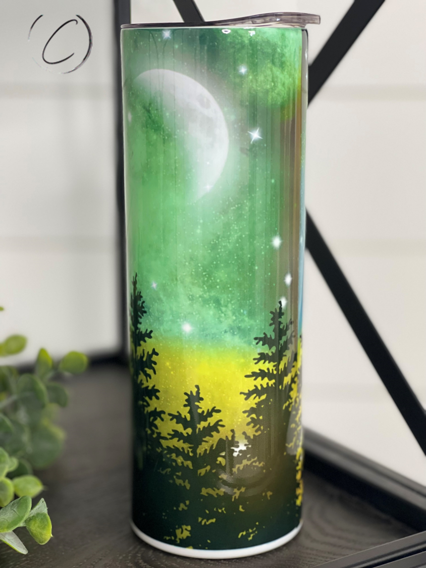 A 20oz skinny tumbler featuring a vibrant Northern Lights design, showcasing beautiful colors and a sleek shape, perfect for hot and cold beverages.