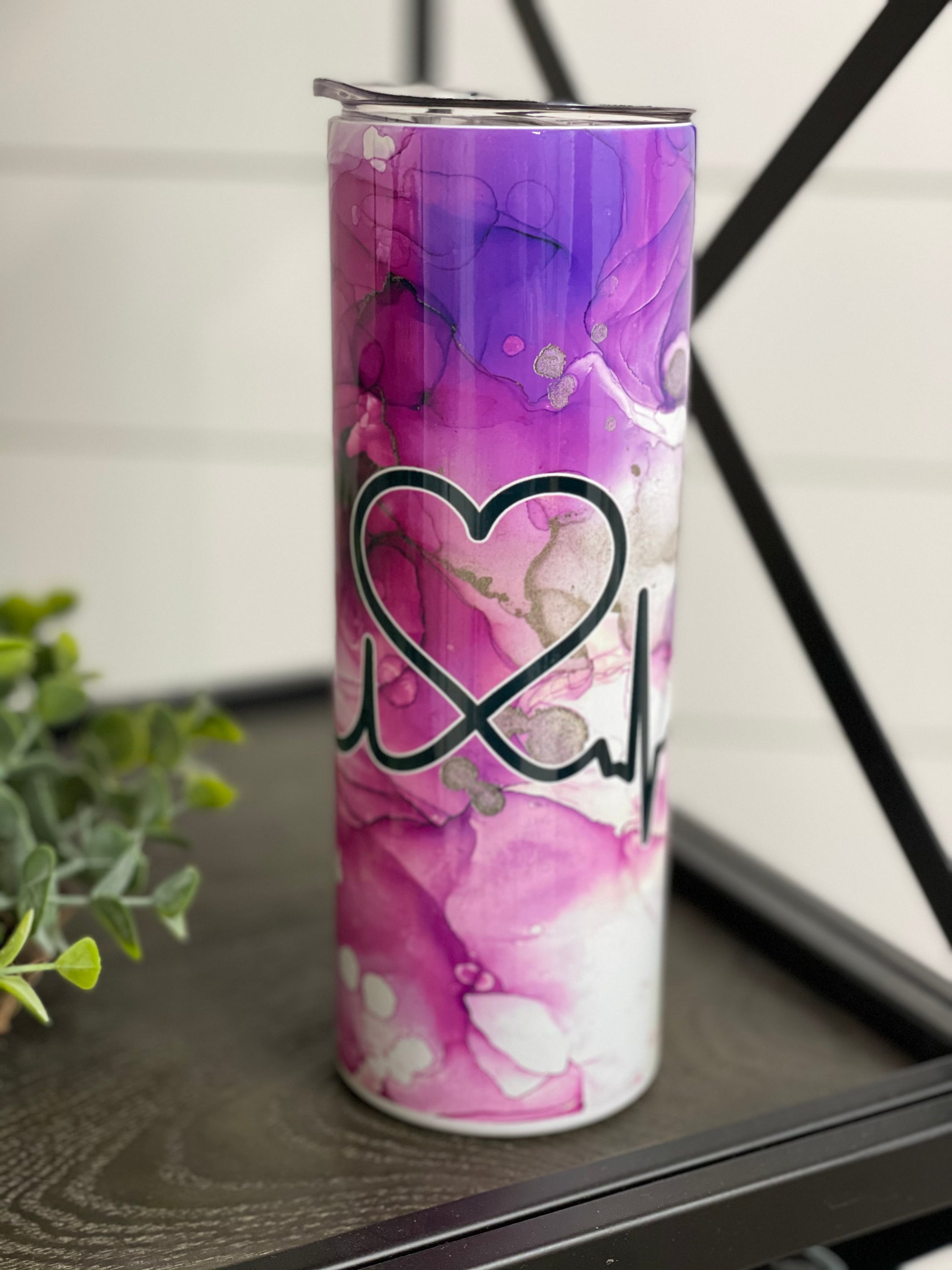 Nurse Beat 20oz Skinny Tumbler with a vibrant design, featuring a reusable straw, showcasing its durable full wrap construction.