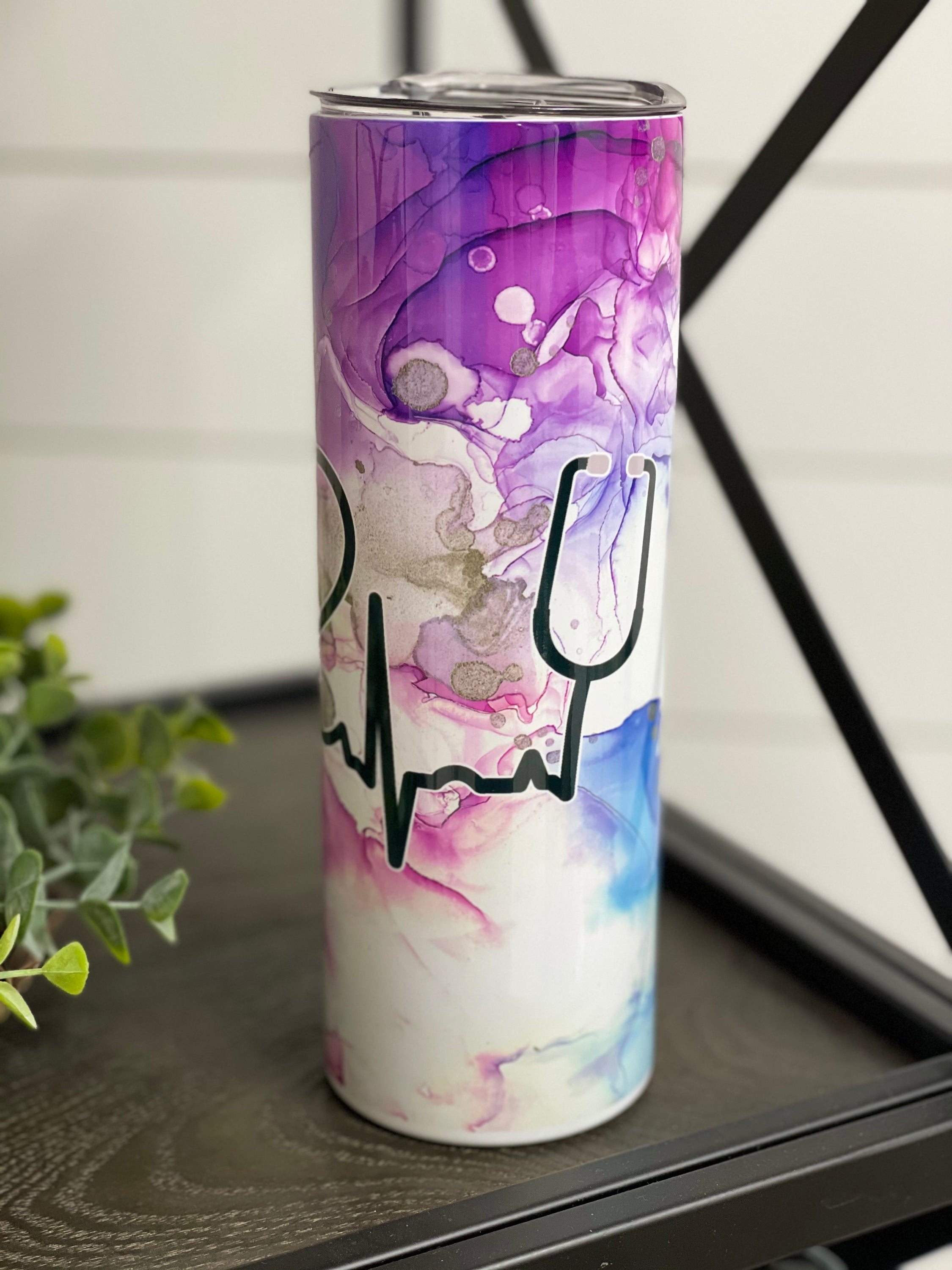 Nurse Beat 20oz Skinny Tumbler with a vibrant design, featuring a reusable straw, showcasing its durable full wrap construction.