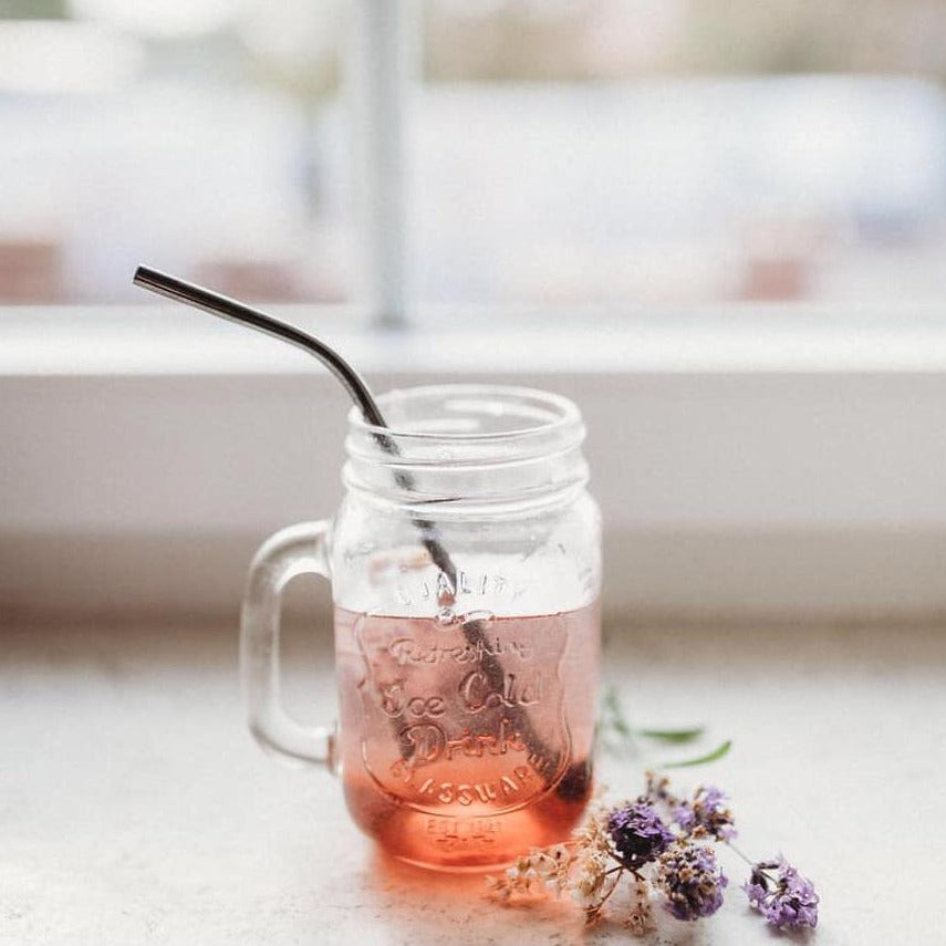 A colorful set of stainless steel straws with a cleaning tool and a drawstring bag, promoting eco-friendliness and humor.