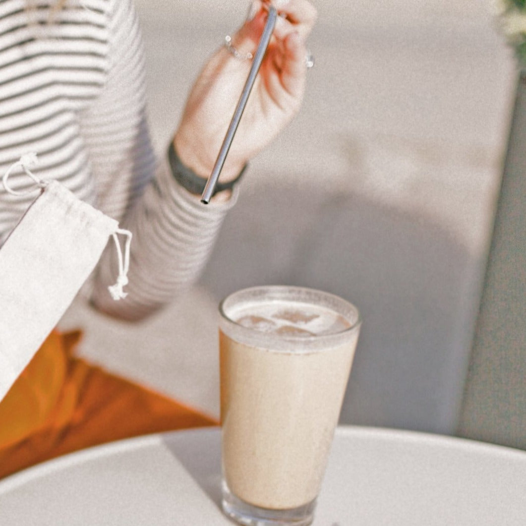 A colorful set of stainless steel straws with a cleaning tool and a drawstring bag, promoting eco-friendliness and humor.