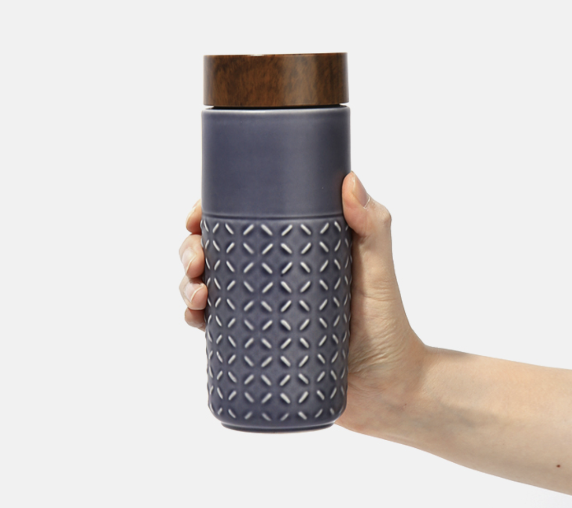 One-O-One Dreamy Starry Sky Ceramic Tumbler showcasing its embossed checkered design and walnut wood-effect lid in various trendy colors.