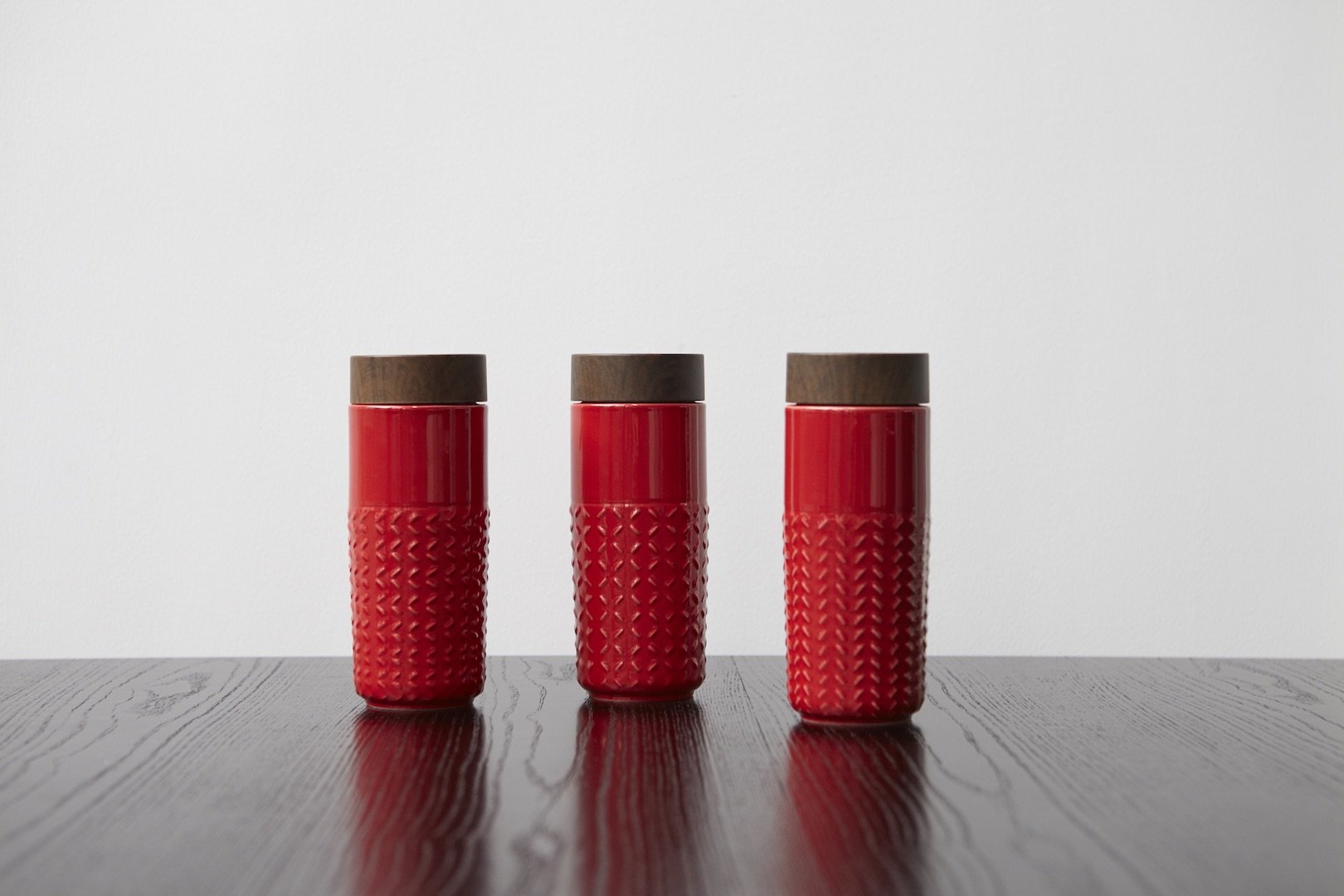 One-O-One Dreamy Starry Sky Ceramic Tumbler showcasing its embossed checkered design and walnut wood-effect lid in various trendy colors.