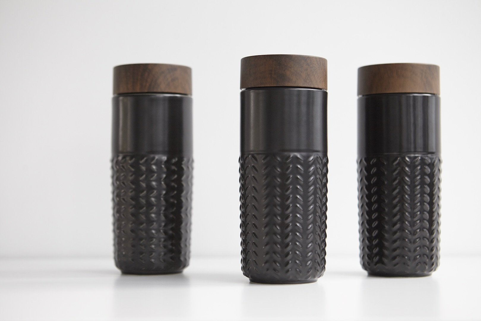 One-O-One Dreamy Starry Sky Ceramic Tumbler showcasing its embossed checkered design and walnut wood-effect lid in various trendy colors.