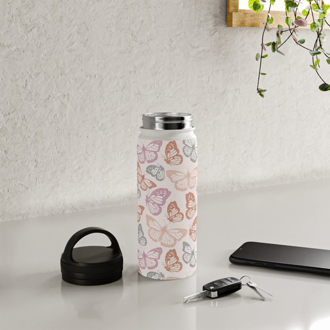 Orange and pink stainless steel water bottle with butterfly handle lid, showcasing a vibrant design and durable construction.