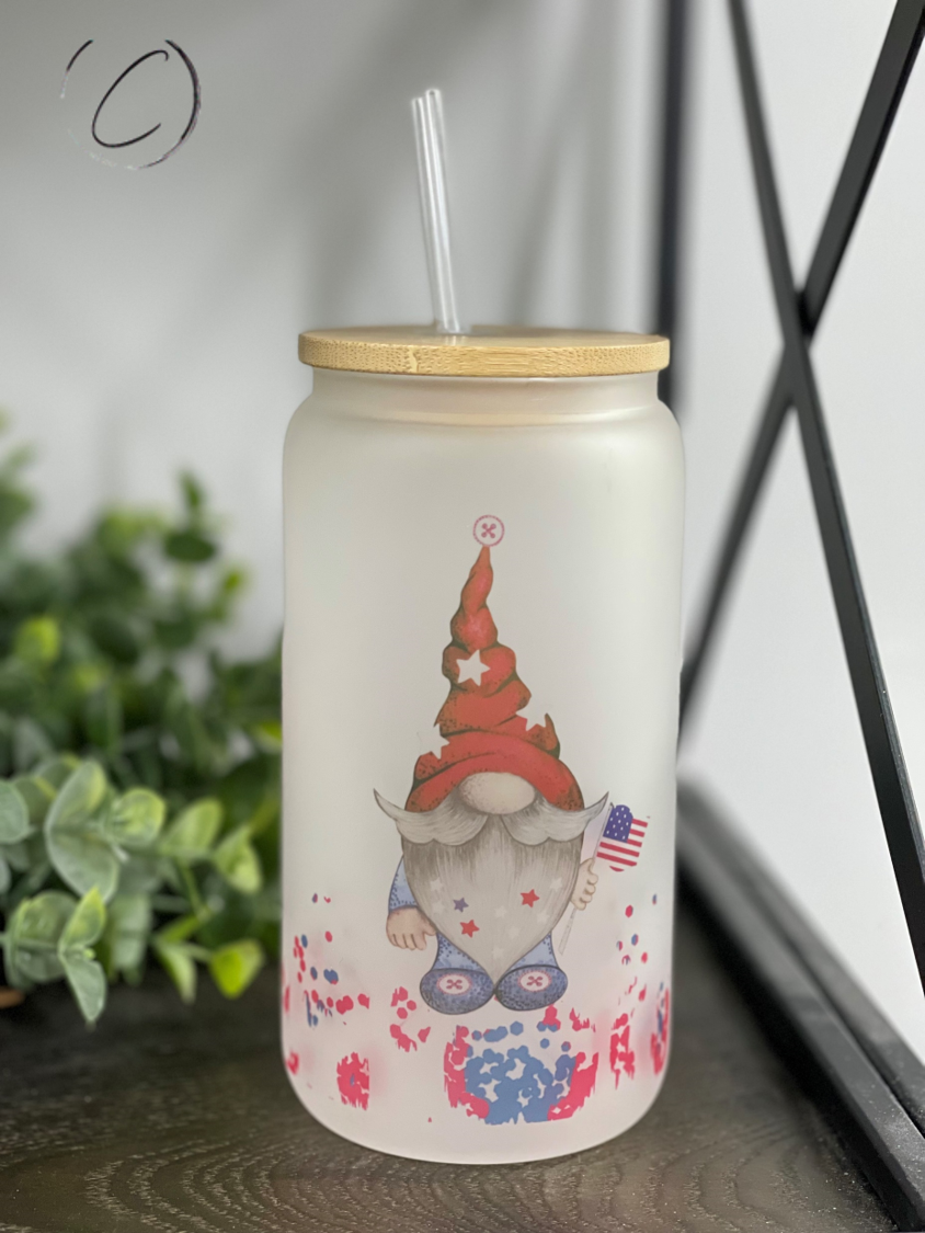 A 16oz Libbey glass tumbler featuring a colorful patriotic gnome design, complete with a reusable straw.