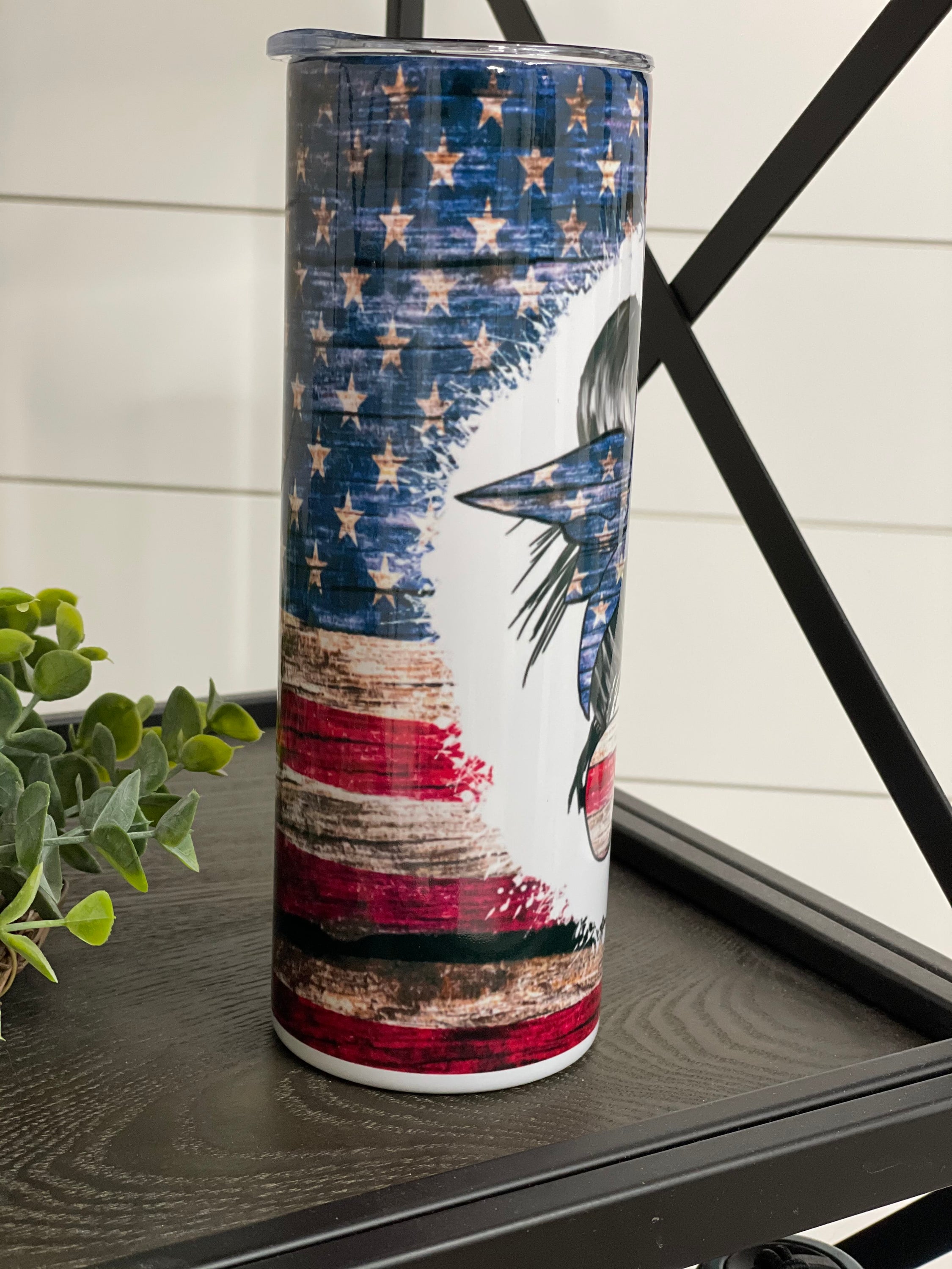 Patriotic Messy Bun 20oz Skinny Tumbler with vibrant design and reusable straw.