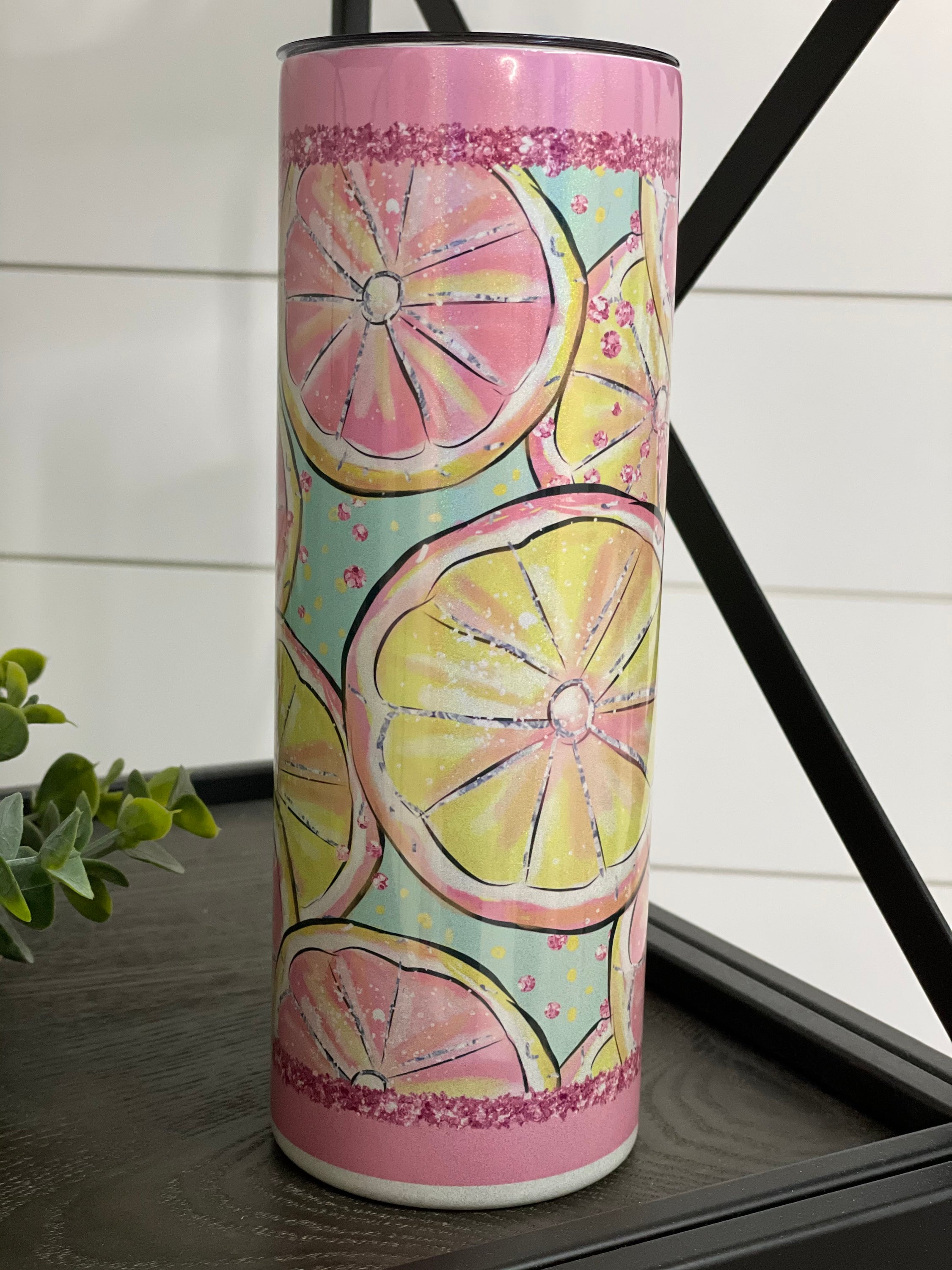 A vibrant Pink Lemonade 20oz Shimmer Skinny Tumbler showcasing a rainbow shimmer effect, complete with a reusable straw.