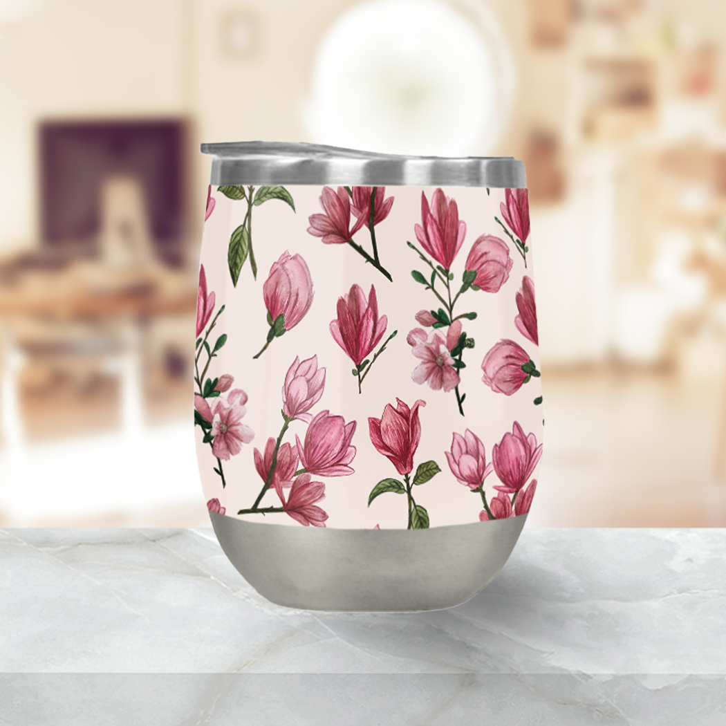 Pink Magnolia Blossom Stemless Wine Tumbler with double-wall insulation and a plastic lid, perfect for outdoor use.