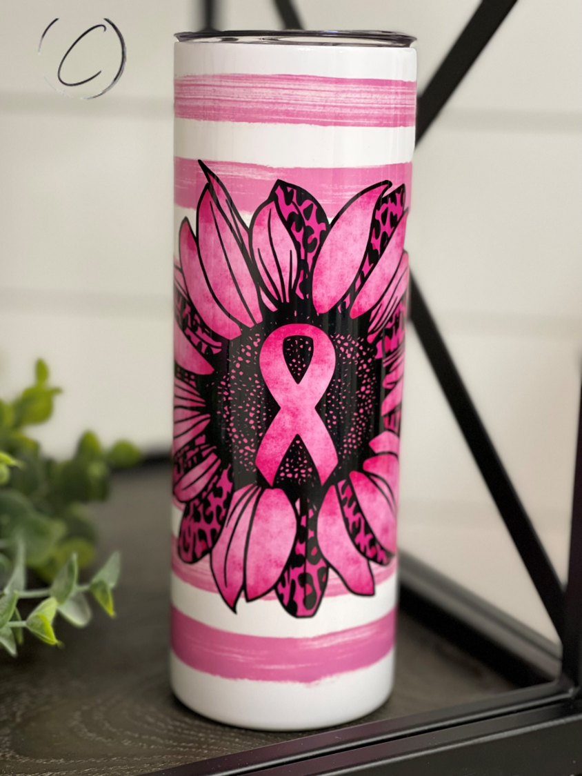 Pink Ribbon Sunflower 20oz UV Pink Skinny Tumbler with a vibrant sunflower design and a color-changing effect in sunlight.