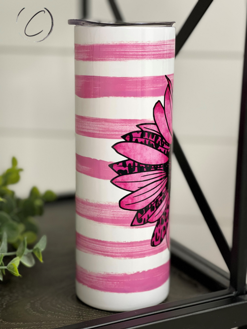 Pink Ribbon Sunflower 20oz UV Pink Skinny Tumbler with a vibrant sunflower design and a color-changing effect in sunlight.