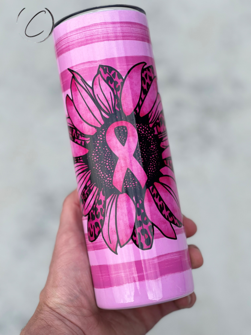 Pink Ribbon Sunflower 20oz UV Pink Skinny Tumbler with a vibrant sunflower design and a color-changing effect in sunlight.