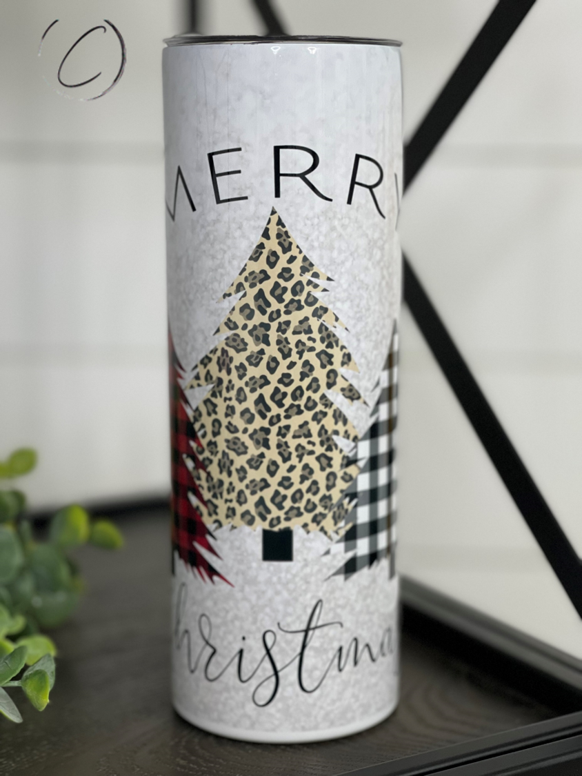 Plaid and leopard patterned 20oz skinny tumbler with a straw, featuring Merry Christmas trees design.