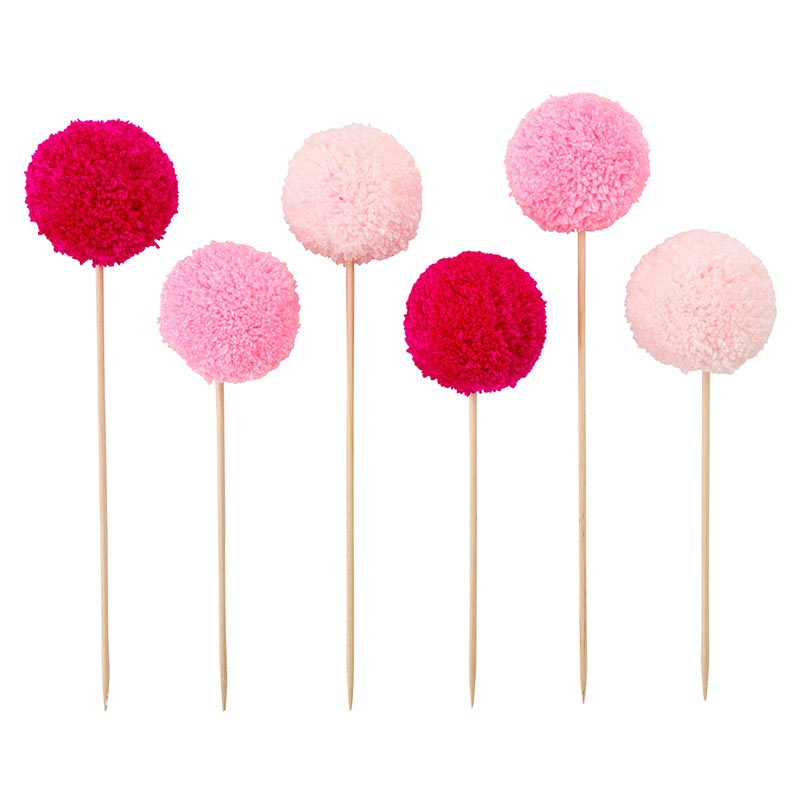 Set of 6 colorful pom pom cake toppers in red, hot pink, and light pink, perfect for birthday celebrations.