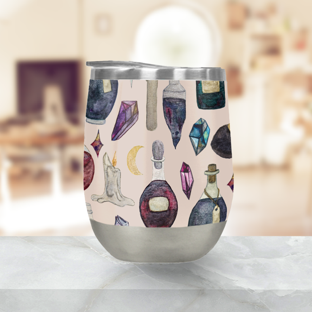 A stylish Potions Pattern Stemless Wine Tumbler made of stainless steel, featuring a whimsical design, perfect for outdoor gatherings.