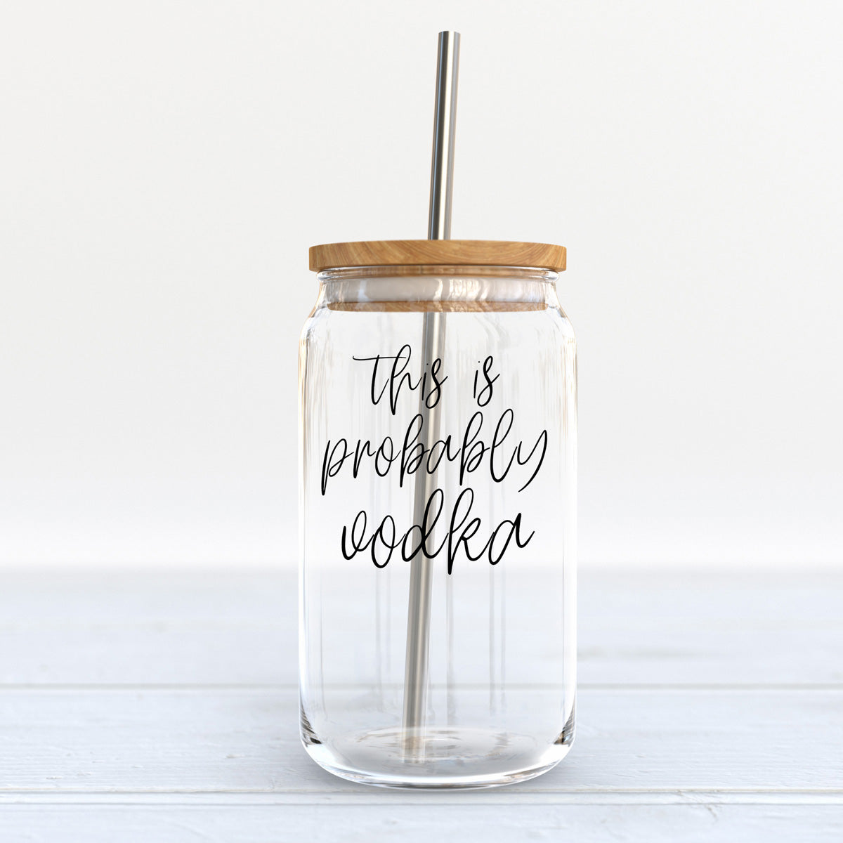 Probably Vodka Set featuring glass cups with bamboo lids and stainless steel straws, perfect for various beverages.